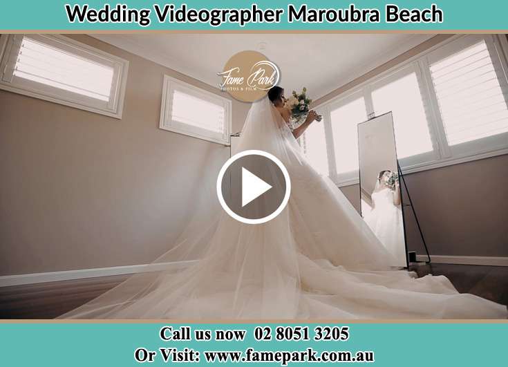 Bride in front of the mirror with bouquet of flowers Maroubra Beach NSW 2035